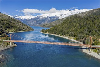 Aerial view of famous orange suspension bridge Puente General Carrera, bridge spans the connection