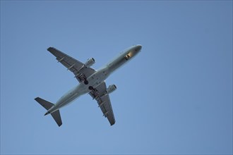 Aeroplane flying in clear blue sky, Toronto Airport, Ontario, Canada, North America