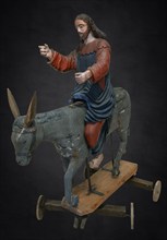 Christ on the palm donkey, on a dark background, wooden figure from around 1400, Museum Bezau,