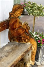 Wooden carved figure of an old woman, farmer's woman, board from the side of a typical bench,