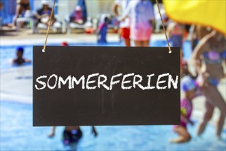 Symbolic image summer holidays: Sign with the inscription SUMMER HOLIDAYS in front of summer