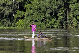 Two young men in a dugout canoe on the Sangha River, Dzanga-Sangha Complex of Protected Areas