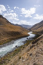 Mountain valley with river between golden meadows, Bolgart Valley, Naryn Province, Kyrgyzstan, Asia