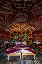 Traditional Kyrgyz yurt for overnight accommodation for tourists, with four beds and carpets, Naryn