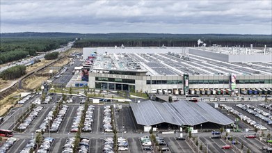 Tesla Giga Factory on the A10 motorway, at the front of the picture is a photovoltaic system above