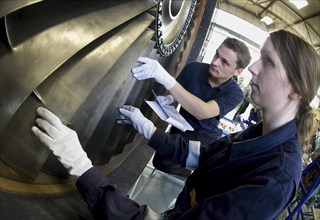 Trainees in the training workshop of Trainico, training as aircraft mechanics on a jet engine,