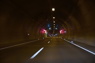 Motorway tunnel A71 with illuminated road and modern light installations offering a perspective