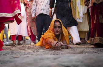 Hindu devotees perform rituals as they offer prayers to the Sun god in the bank of Brahmaputra