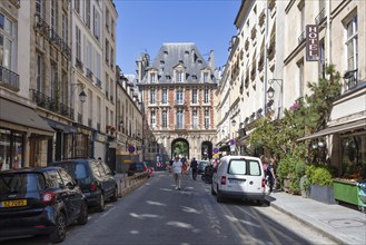 Lively Parisian street with historic buildings and passers-by, Paris