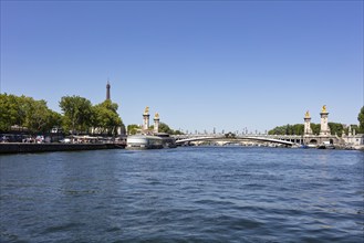 Cityscape with bridge and the Eiffel Tower in the background on a sunny day, Paris