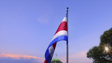 Costa Rica Flag proudly waving in San Jose. Large Costa Rica flag is flying high in city center