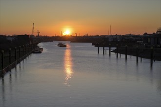 Ships on the Rhine-Herne Canal, Duisburg lock, at sunset, Duisburg, Ruhr area, North