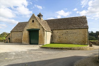 Historic nineteenth century farmyard stone barn building, Yanworth, Gloucestershire, England, UK