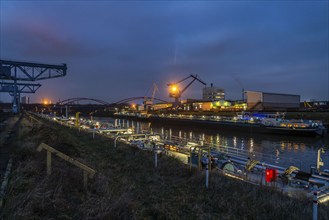 Cargo ships and cranes in Essen city harbour, on the Rhine-Herne Canal, motorway bridge of the A42