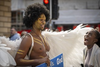 Street performers with angel wings, world's largest cultural festival The Fringe, High Street,