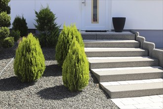 Well-kept front garden with block steps, ornamental stones and planting