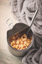 Open tin can, with corn, top view, selective focus, no people, close-up