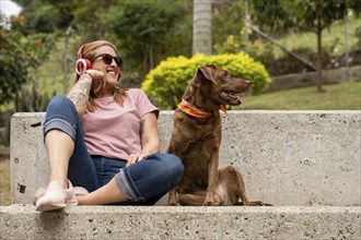 Portrait of a beautiful young woman enjoying outdoors and listening to music, accompanied by her