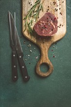 Fresh, raw rib eye steak, on a chopping board, top view, no people