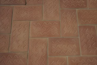 Terracotta floor tiles laid with geometric zigzag patterns, Patmos Cotto brickworks, traditional