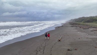 Two tourists on the beach, coast with rainforest, Tortuguero National Park, Costa Rica, Central