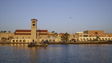 Church at the harbour, surrounded by calm sea and clear blue sky at morning light, Church of the