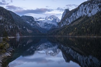 The Vordere Gosausee lake in autumn with a view of the Dachstein mountain range. The Gosaukamm on