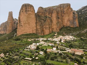 View of a small village surrounded by huge rocks and green landscape that gives a quiet and rural