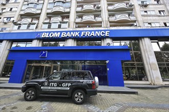 Bucharest, centre, building of Blom Bank France, in front of it car of the security company,