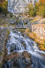 Rushing stream flowing over rocks under a small bridge, St. Beatus Caves, Switzerland, Europe