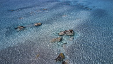 Crystal-clear sea water with visible stones and a calm atmosphere, Elafonissi, lagoon, south-west