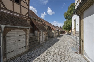 Inner courtyard with former so-called Kirchgaden, barns and St John's Church in the historic