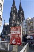 Advertising for the corona vaccination, campaign on Citylight posters at Cologne Cathedral, view of