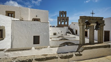 Whitewashed buildings and arches in the Greek monastery with blue sky, Inside the monastery, Agiou