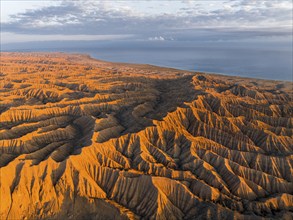 Landscape of eroded hills at Lake Issyk Kul, Badlands at sunrise, aerial view, Canyon of the