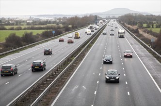 Traffic driving in winter on the M5 motorway near Bridgwater, Somerset, England looking north