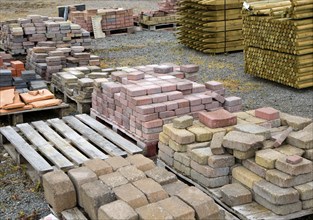 Clay bricks piled up in builder's yard, UK