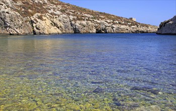 Shoreline clear blue sea water, Mgarr ix-Xini coastal inlet, island of Gozo, Malta, Europe