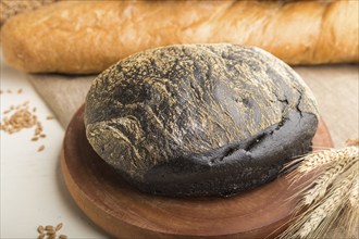 Different kinds of fresh baked bread on a white wooden background. side view, close up, selective