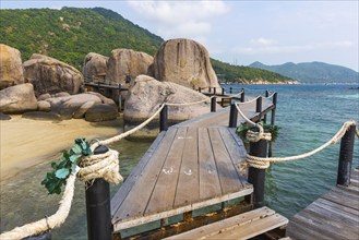 Wooden jetty with granite rocks at the entrance area of Nang Yuan Island, island, holiday island,