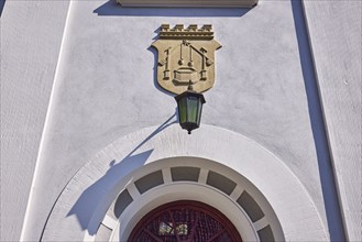 Facade of a house in the classicist style with the coat of arms of the salt boiling trade and