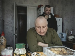 Gennady, 48, and a comrade in the kitchen of the house where his unit has taken up position,