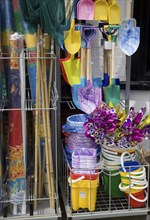 Traditional seaside buckets and spades on sale outside a shop in Aldeburgh, Suffolk, England,