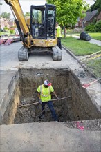 Detroit, Michigan, Workers replace old lead water service lines with copper pipes. Lead is harmful