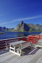 Veranda with benches by a fjord, Rorbuer, holiday homes, Hammoy, Lofoten, Nordland, Norway, Europe