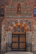 Odense, early Gothic St Albani Church, Roman Catholic church, entrance portal with wood carvings,