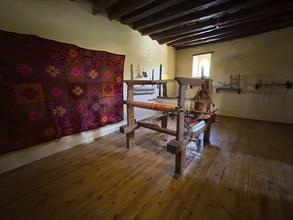 Room with traditional loom left on wall traditionally woven carpet in Xopatera Tower Tower of