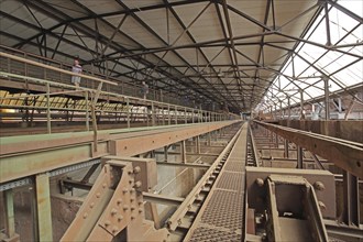 Interior view of the Möllerhalle with steel girders and long corridors with tourists, UNESCO