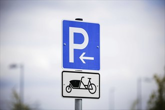 Symbolic photo. A sign for reserved parking spaces for cargo bikes on a newly built car park.