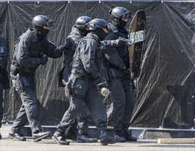 Police officers from the Berlin Special Operations Command, SEK, simulate an attack during an